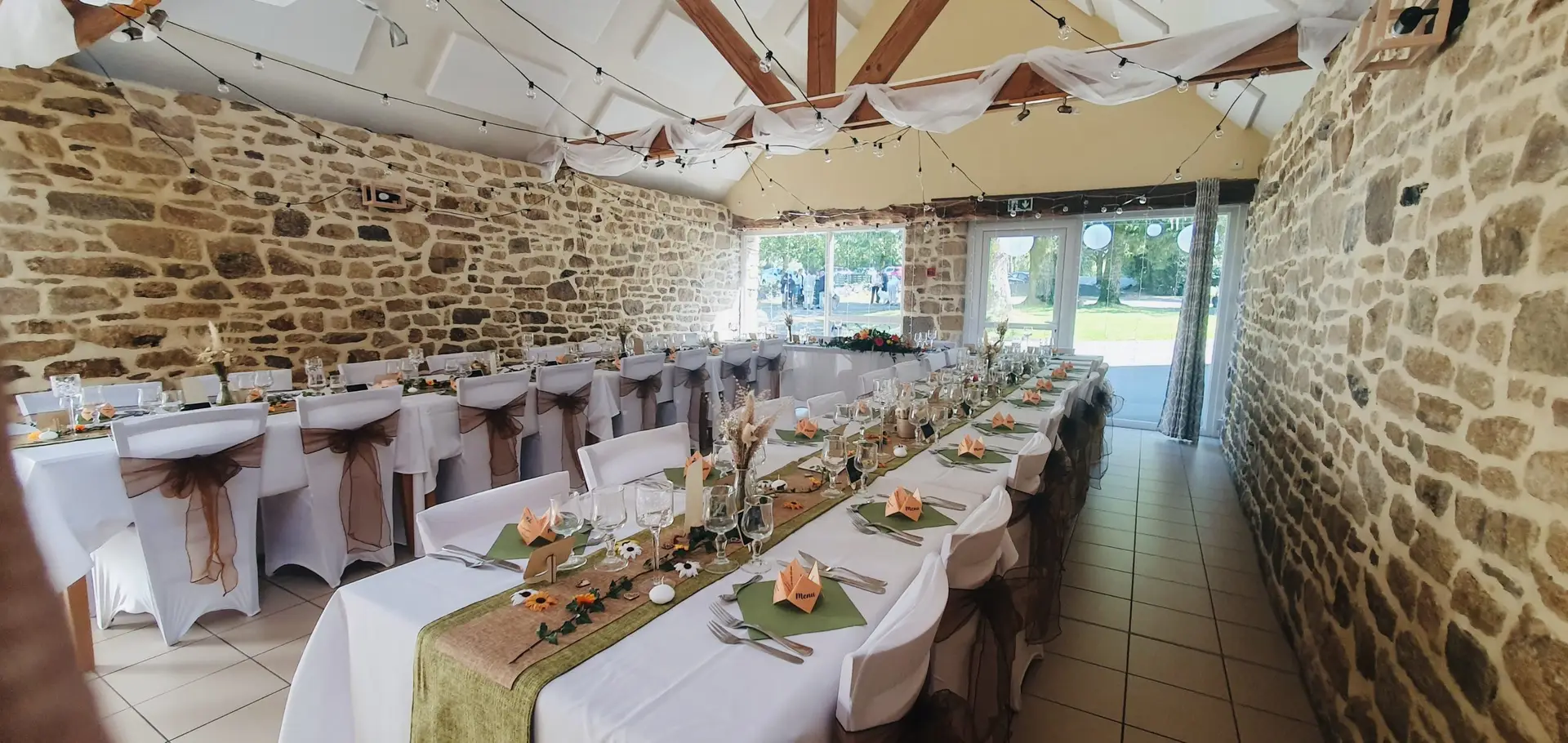 Salle Ty Braz en pierre, tables dressées pour un repas de fête